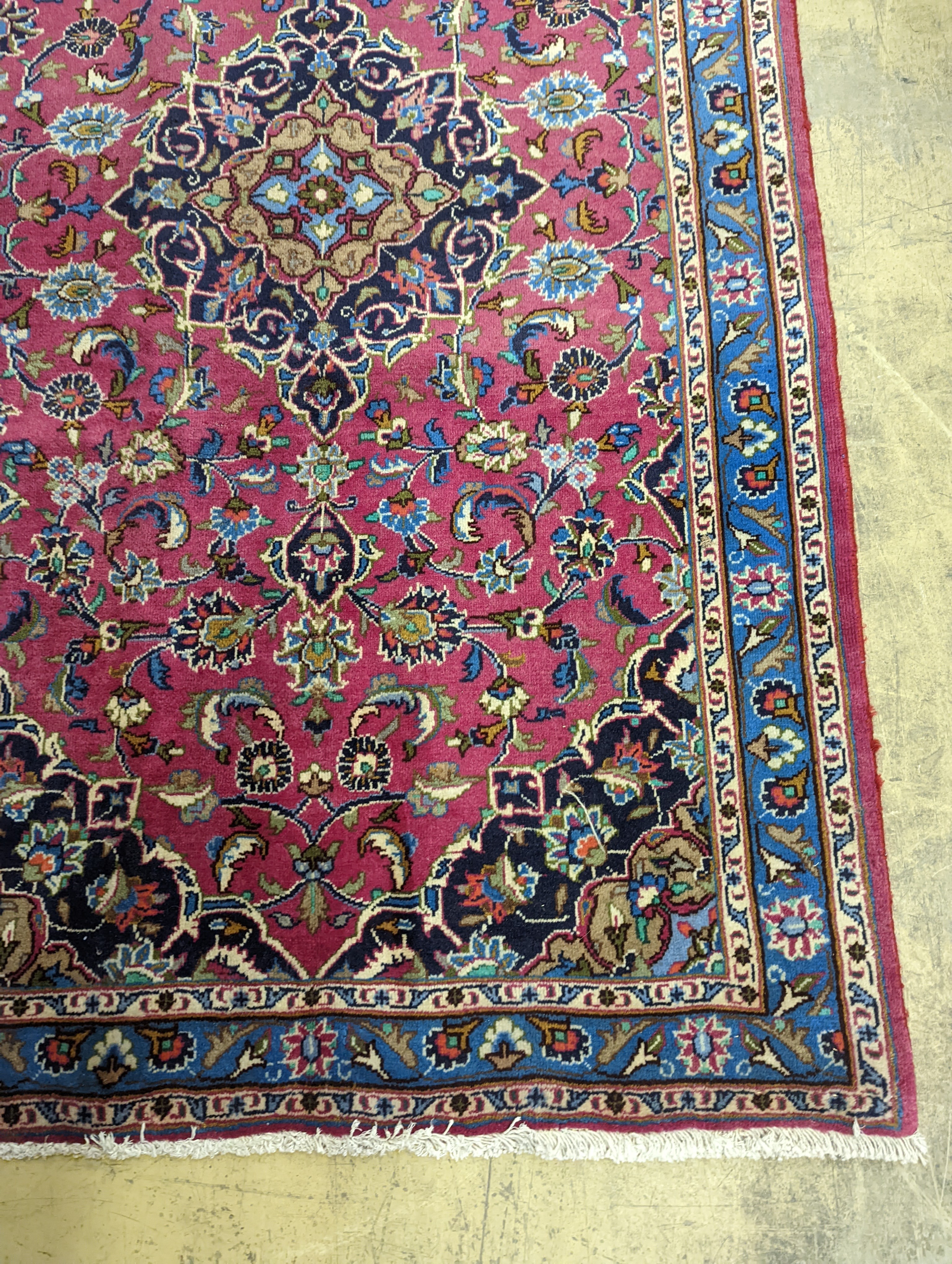 A Najaf Abad claret ground rug, 200 x 114cm
